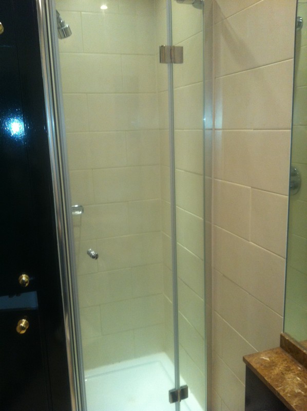 Frameless glass shower enclosure with chrome fittings in Waterloo