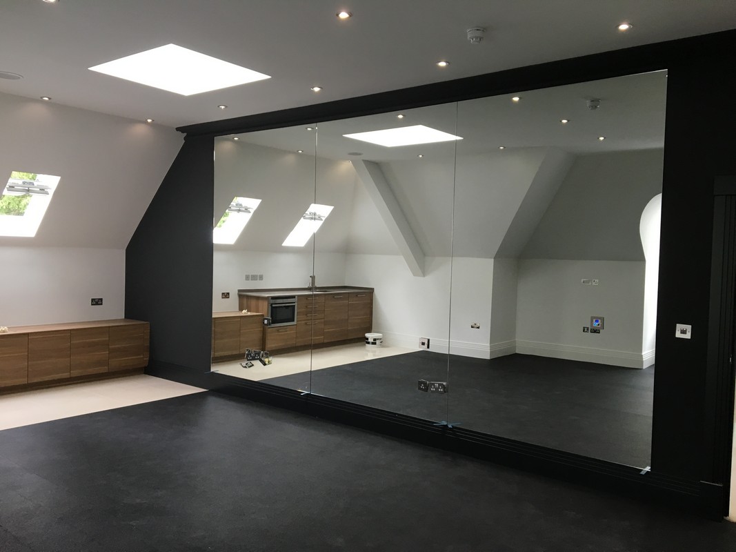 Frameless glass wall dividing loft conversion in Waterloo